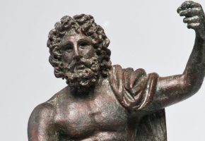 Titelbild: Ein Ausschnitt von einem Mann aus Bronze. Sein Oberkörper ist nackt. Der linke Arm ist gehoben. Auf seiner linken Schulter ist ein Tuch.